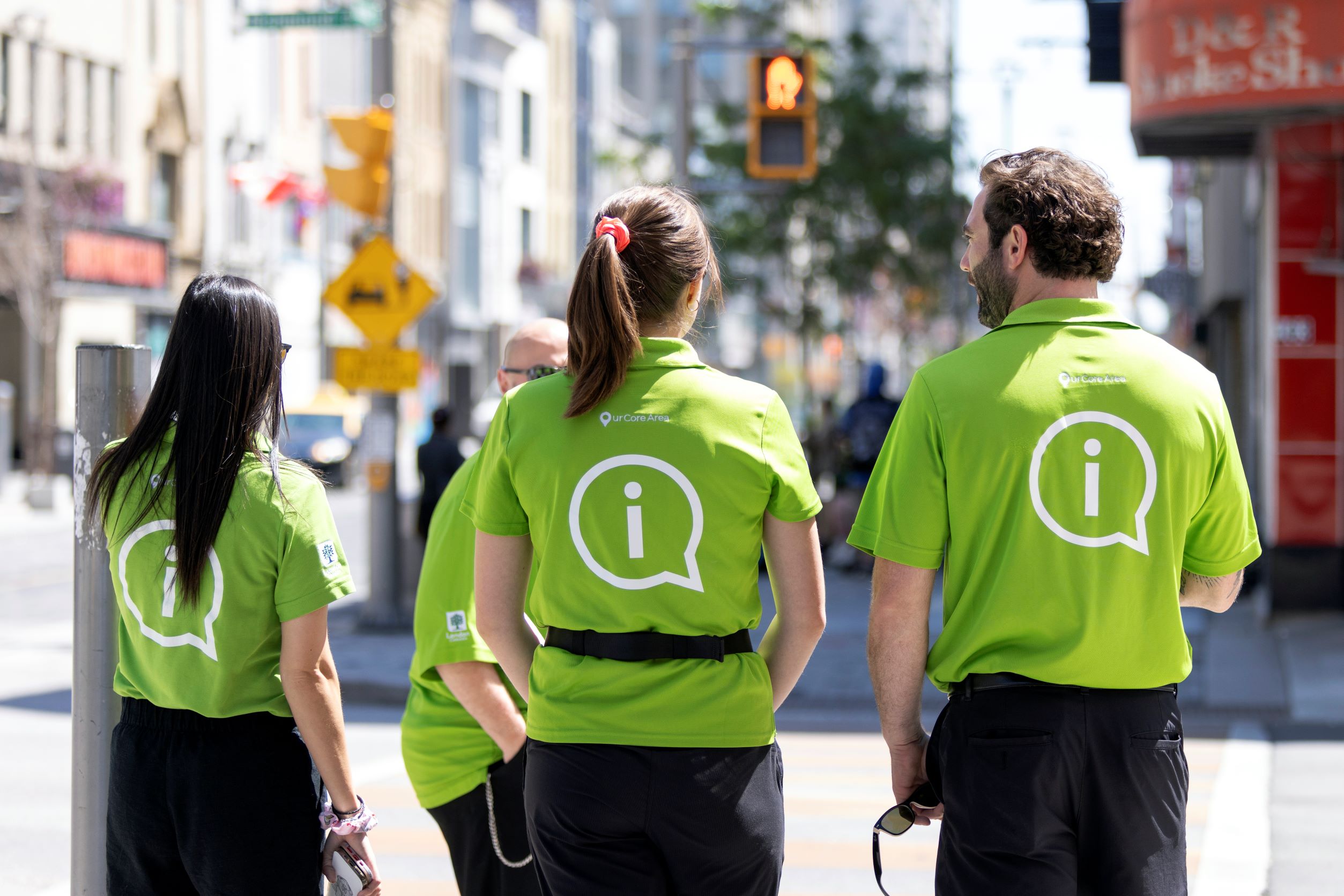 Core Area Ambassadors wear bright green shirts with an 'i' on the back. 