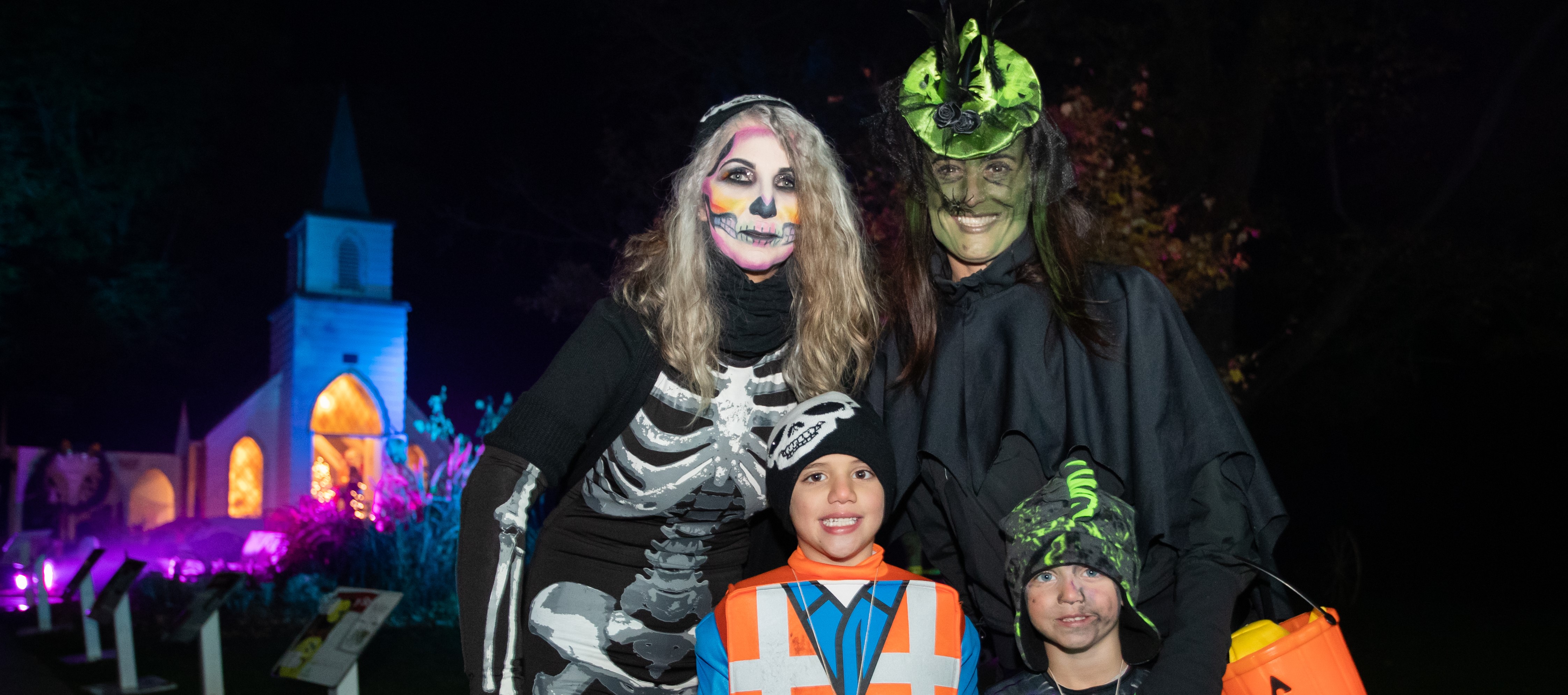 Family posing for a picture at Storybook Gardens' StoryBOO! Halloween event. 