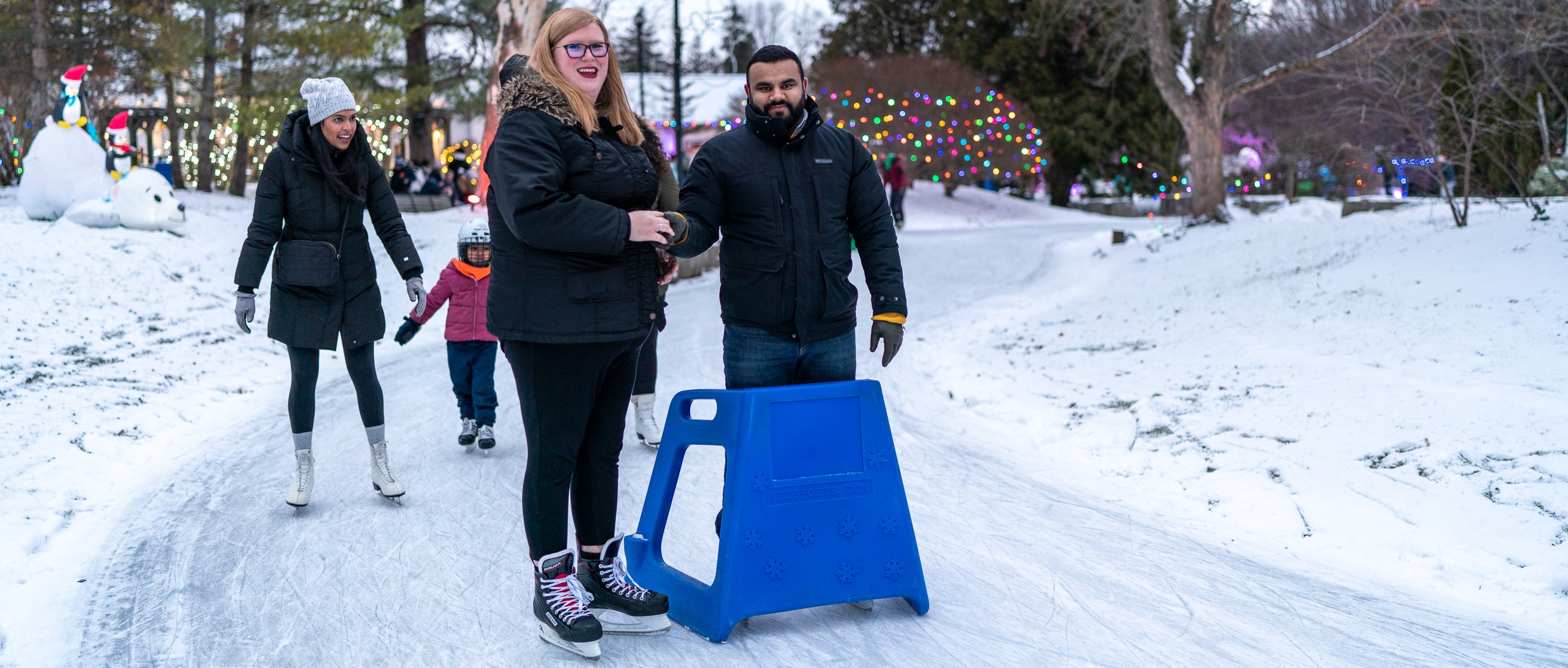 Couple holding hands on Storybook Gardens' skate trail