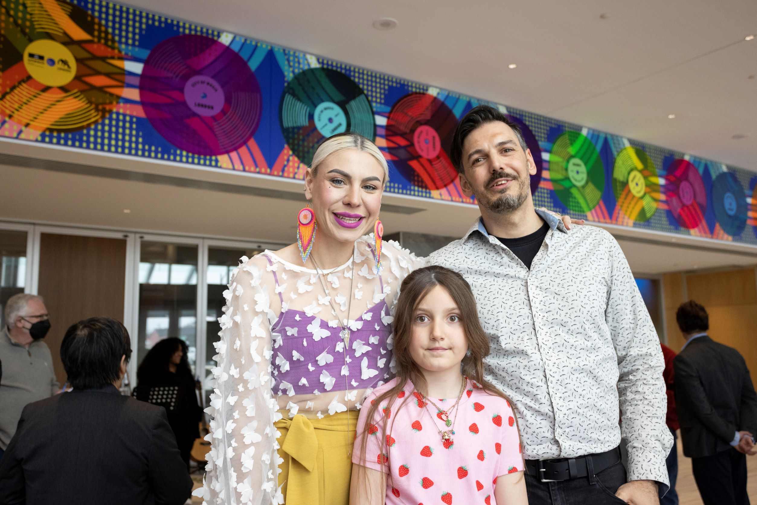 Caption: Local artist Tova Hasiwar and her family pose for a picture in front of the London UNESCO City of Music Mural