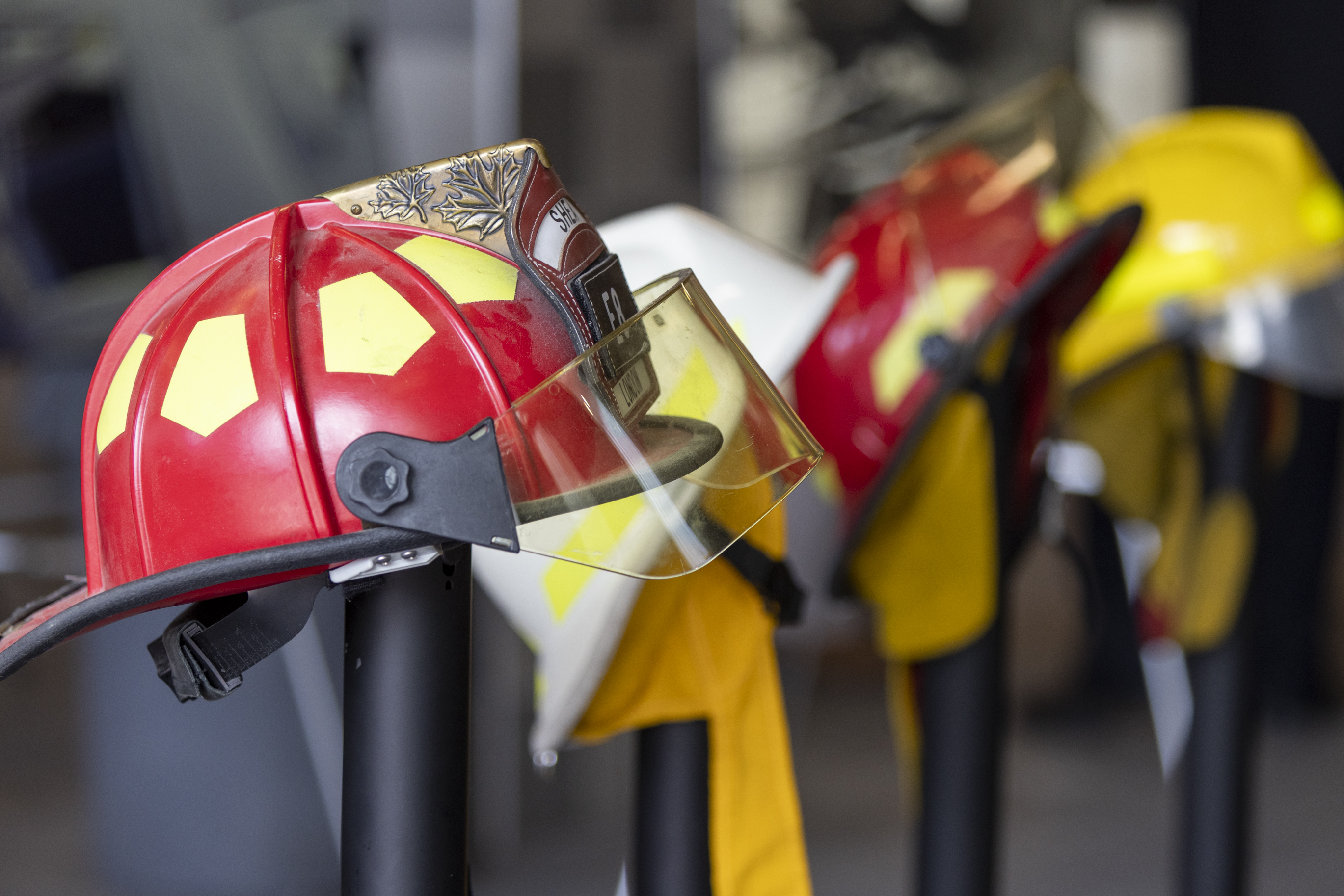 Red, white and yellow fire helmets