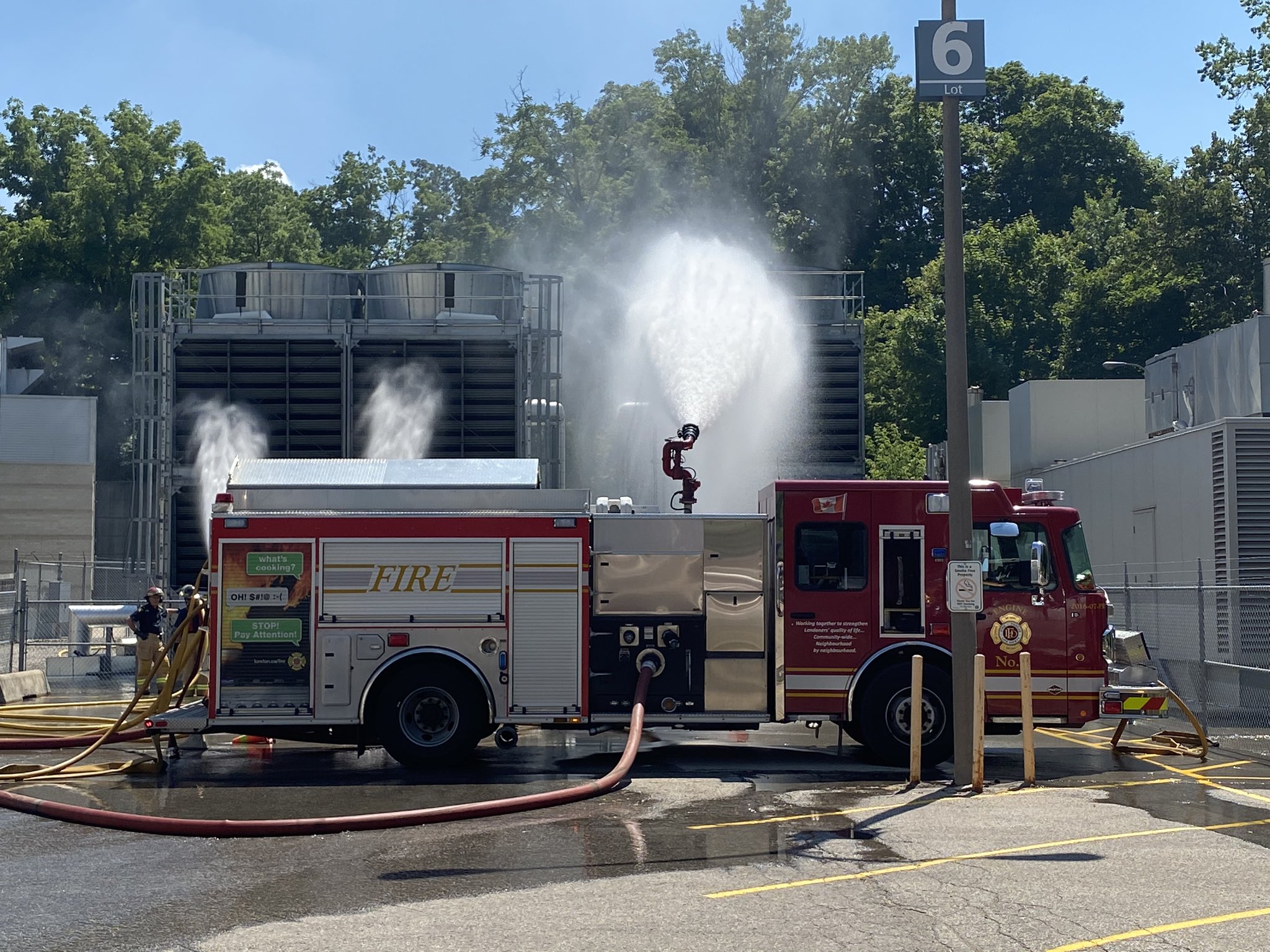 A fire truck spraying water out of a hose attached to the truck