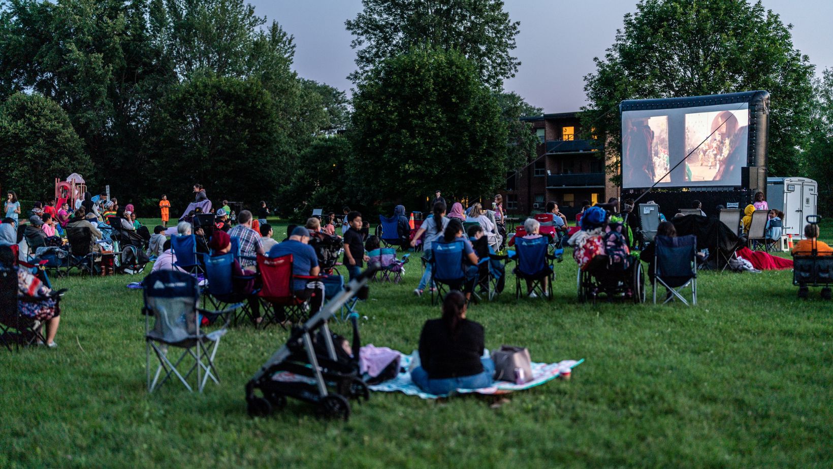 People watching a movie outdoors on an inflatable screen