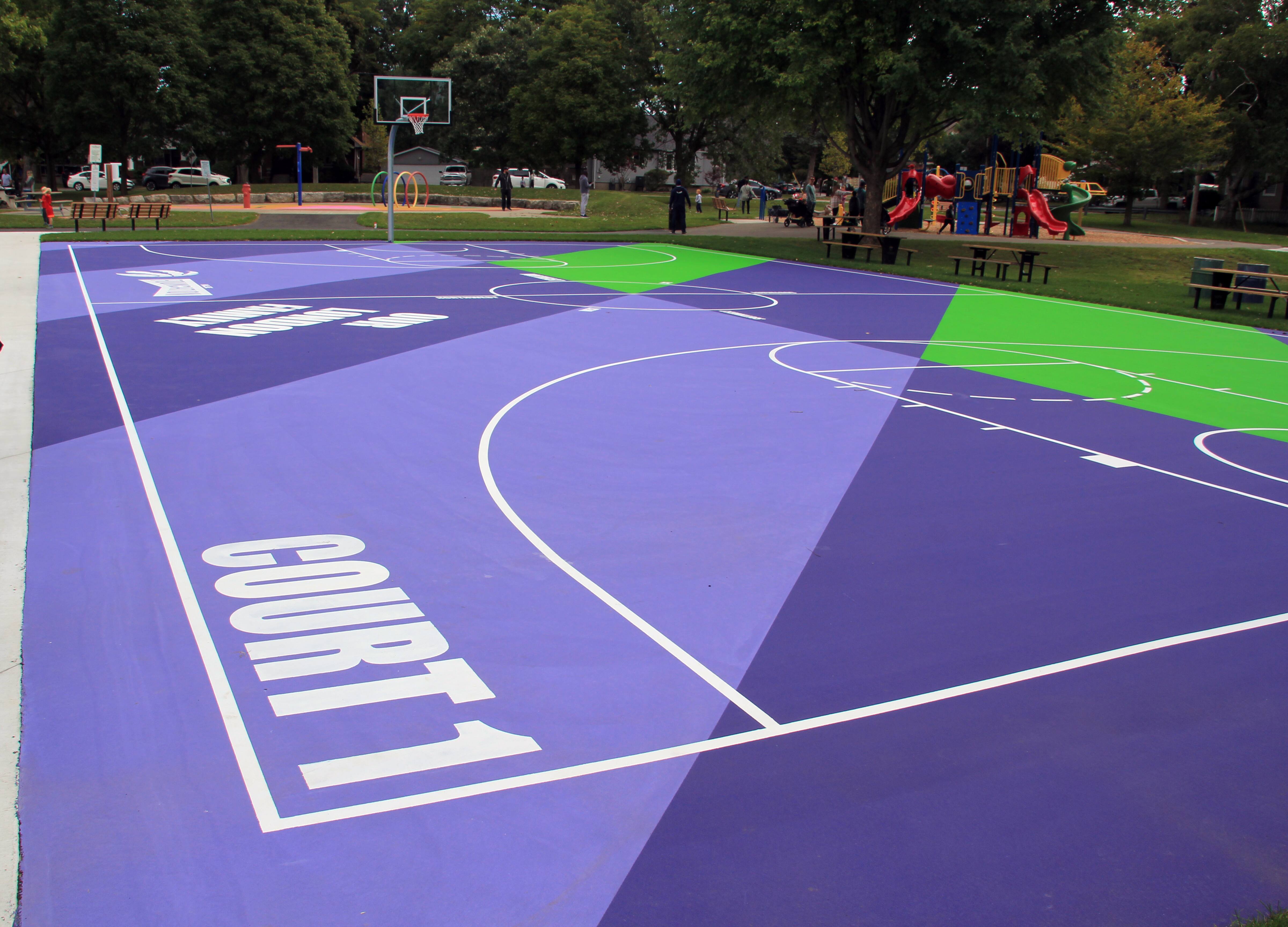 The upgraded basketball courts in West Lions Park and the purple and green court surface.