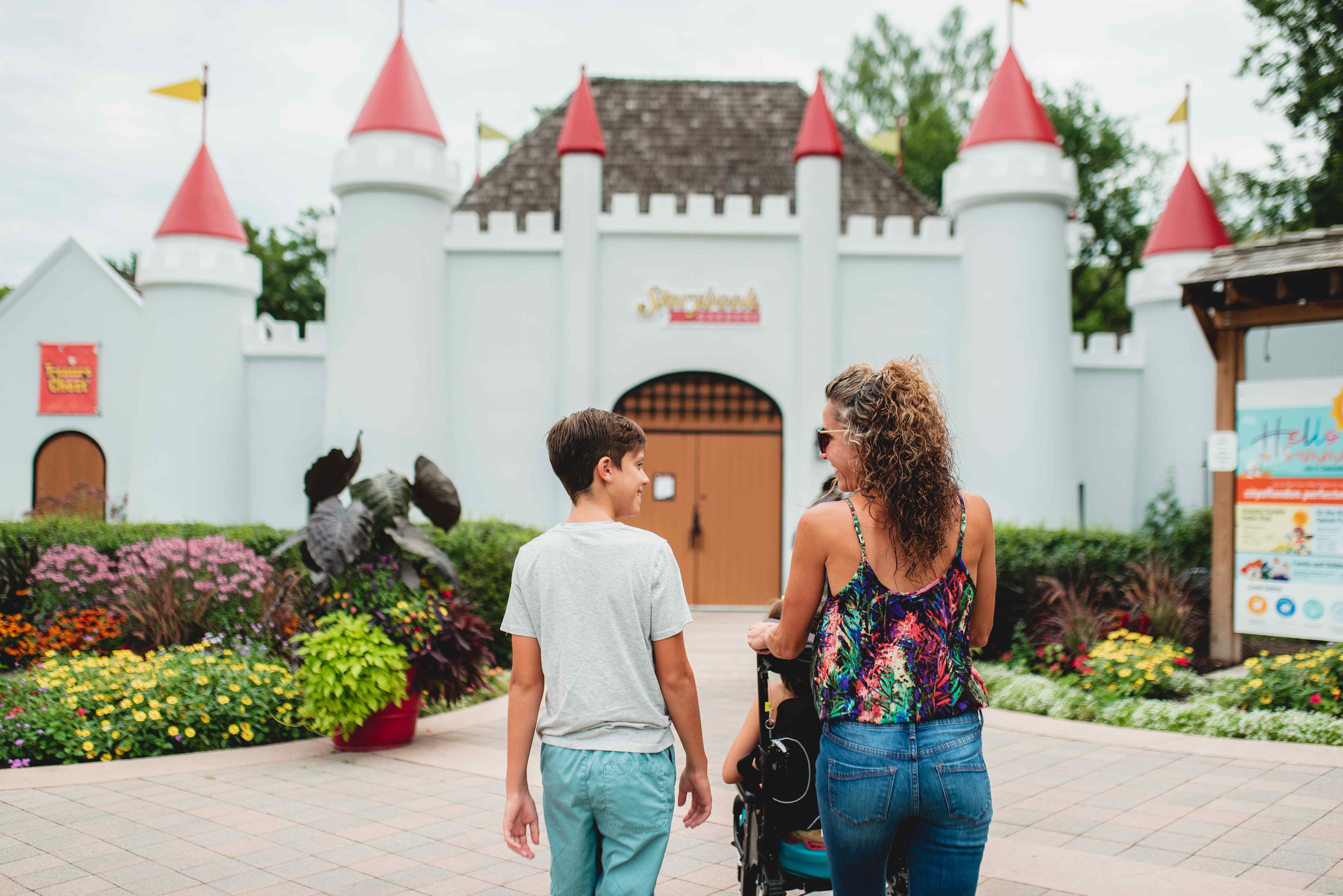 Family walking into Storybook Gardens' castle