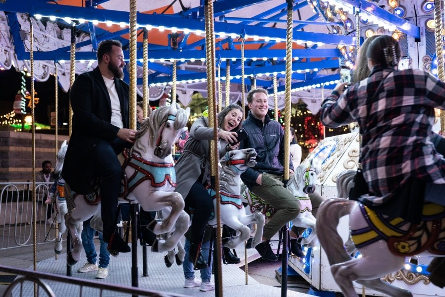 A photograph of the free carousel in front of Canada Life Place.