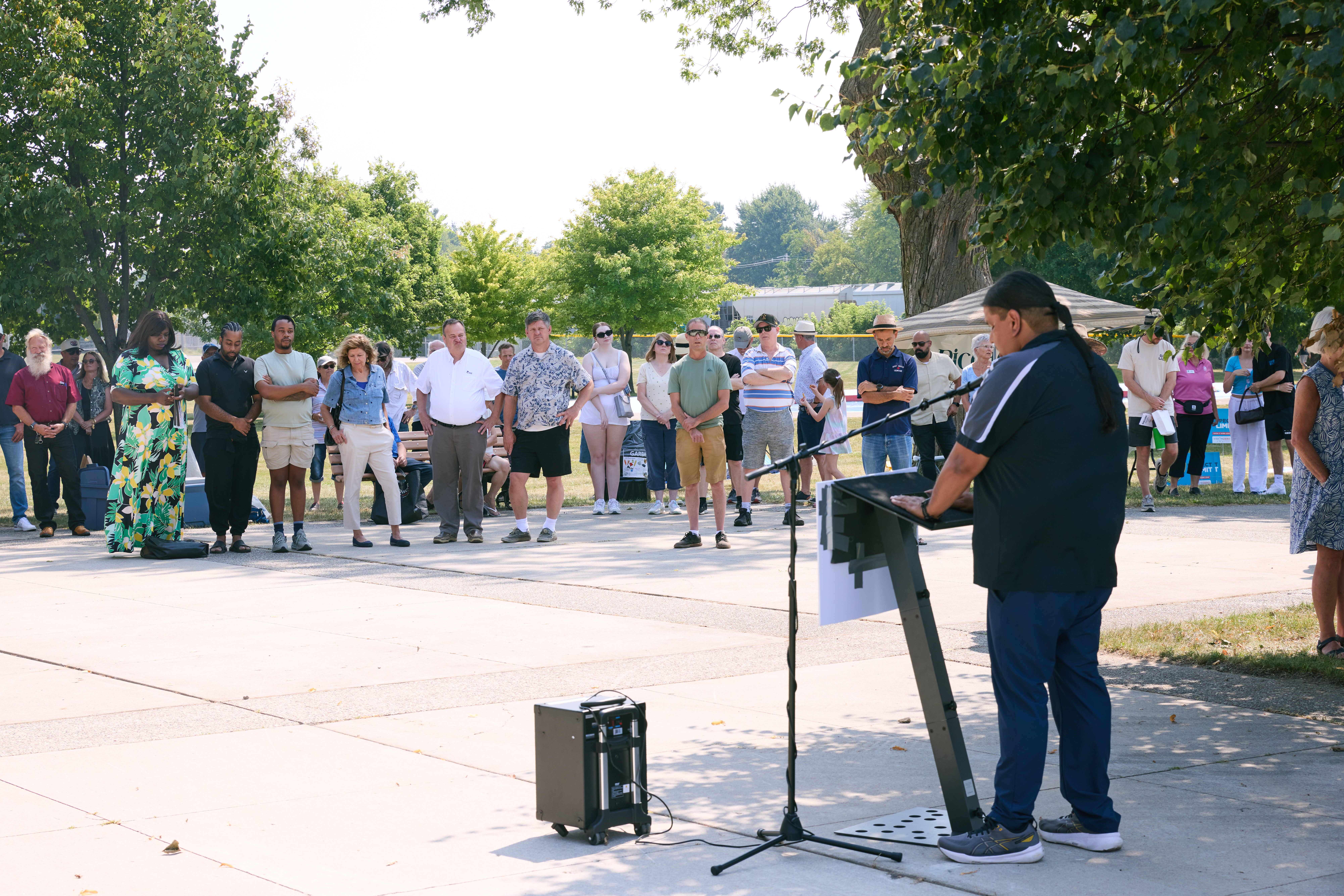 A crowd gathers for the speaking portion of the event as Joel Kennedy, Executive Director of N’Amerind, delivers a traditional Indigenous opening acknowledgement.