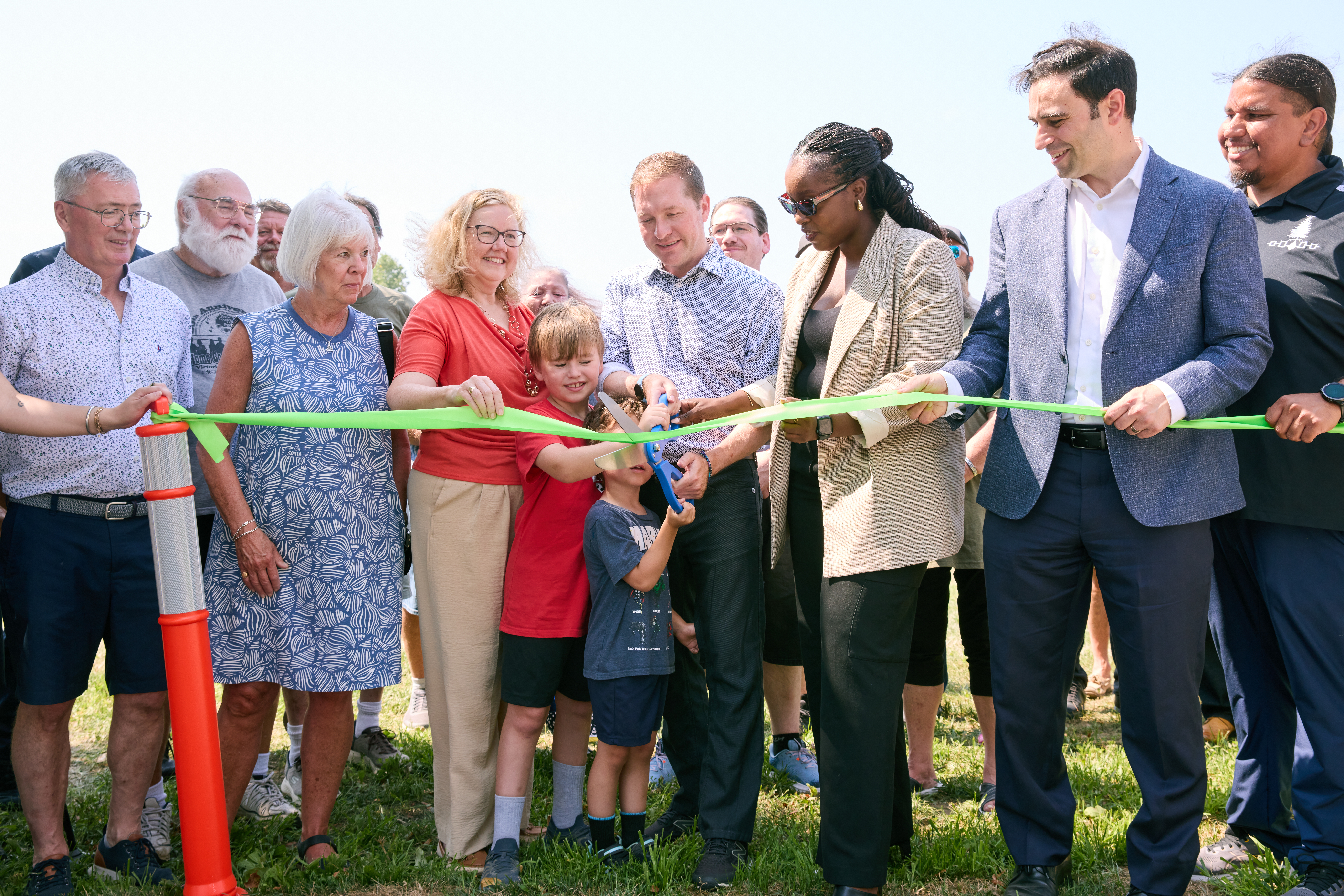  A ribbon is cut in McMahen Park together by Adrian Hey, granddaughter of Thornton Archibald McMahen; Councillor Susan Stevenson, Ward 4; Mayor Josh Morgan; Arielle Kayabaga, Deputy House Leader of the Government and MP for London West; Peter Fragiskatos, Parliamentary Secretary to the Minister of Immigration, Refugees and Citizenship and MP for London Centre; and Joel Kennedy, Executive Director of N’Amerind.