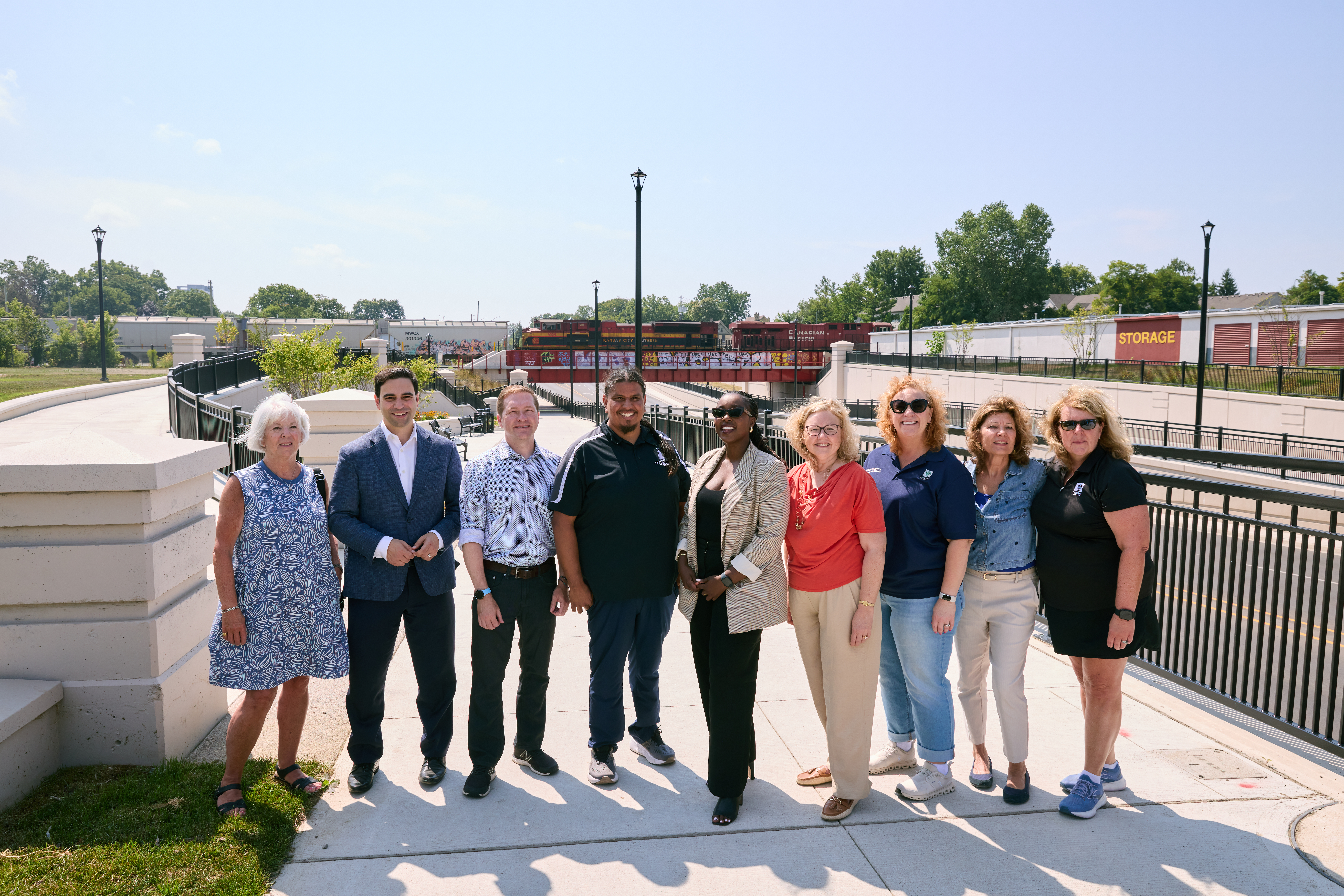 Government representatives, special guests, and City staff gather in front of the Adelaide Underpass.