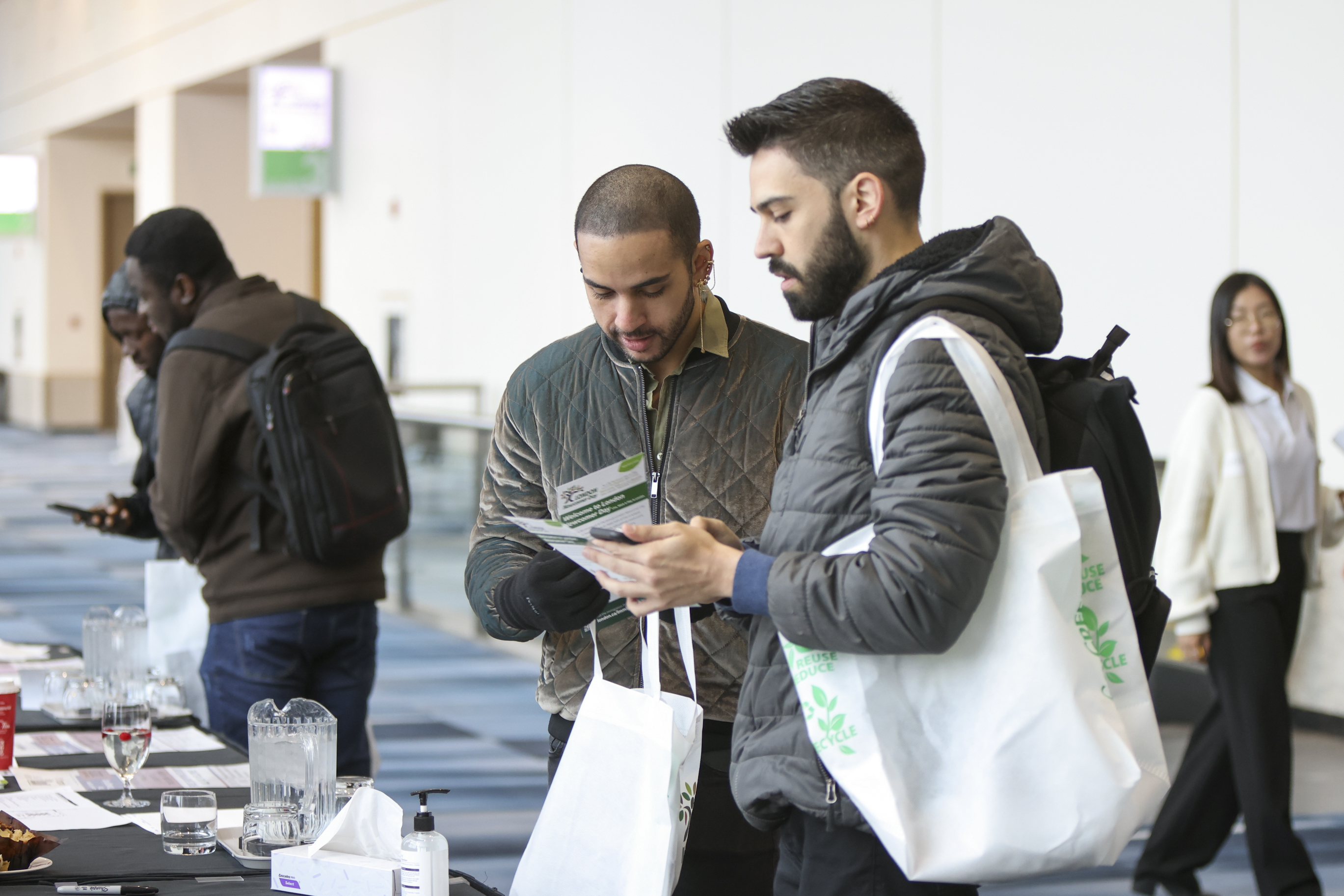Two people collecting information at the Newcomer Day event