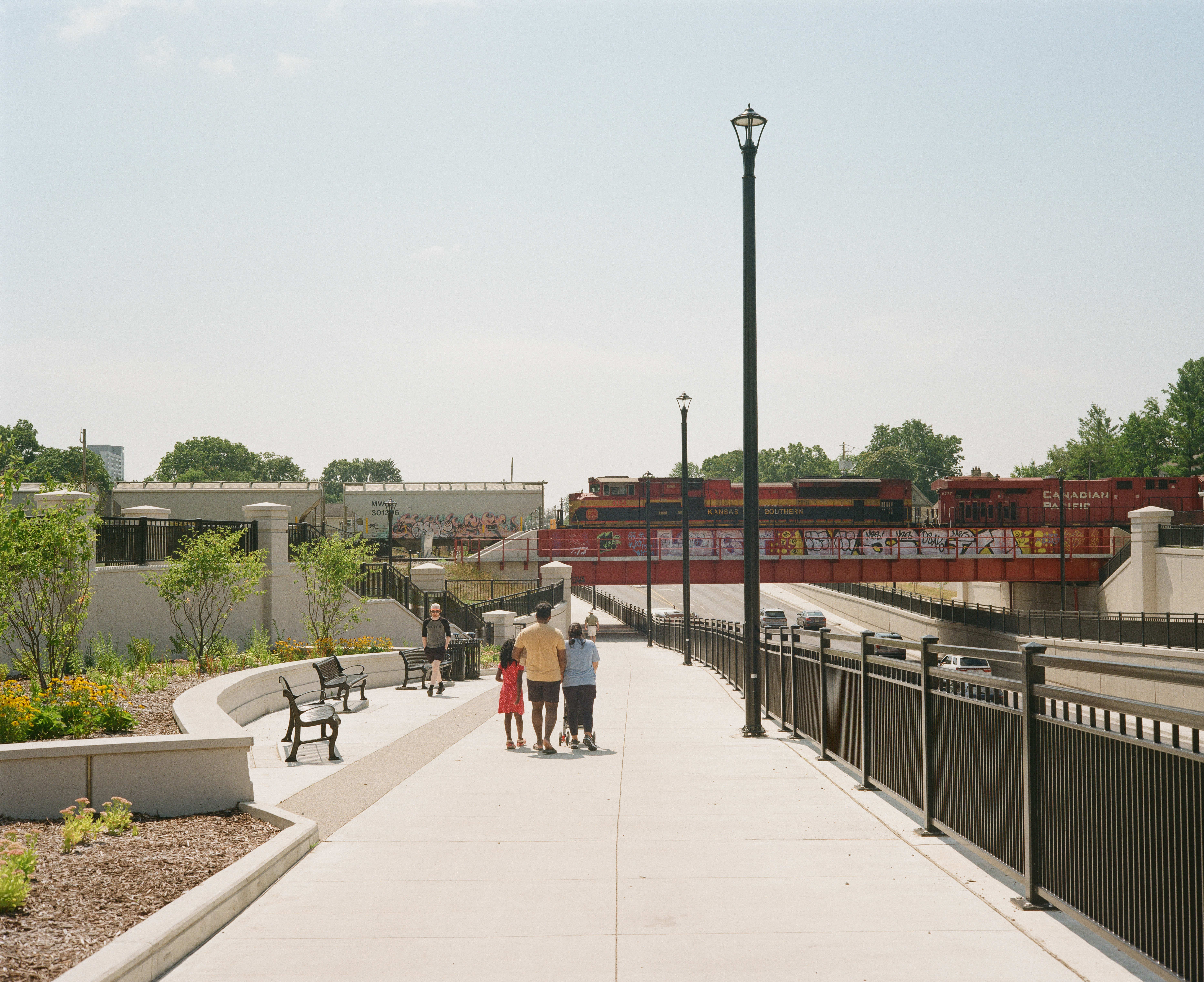 A family walks underneath the Adelaide Underpass in London Ontario.