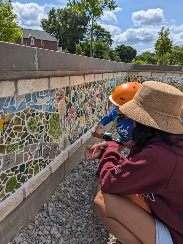 Children look at the Lorne Avenue Park Mosaic wall.