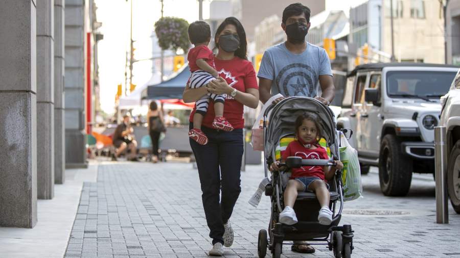 A family walks on Dundas Place together