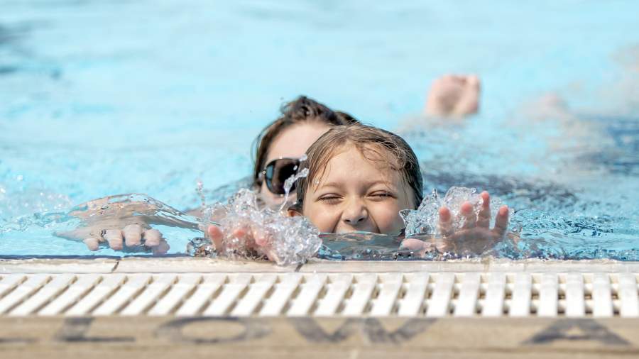 Swimming with kids at an outdoor pool