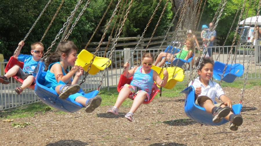 Children enjoying the Storybook Gardens swings