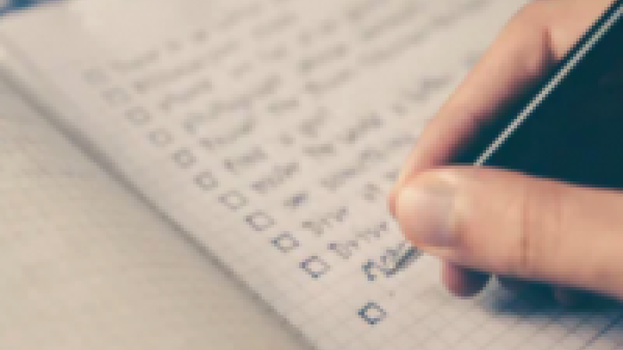 image of a check list and a person checking items off the list
