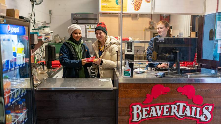 Ladies behind a counter selling Beavertails
