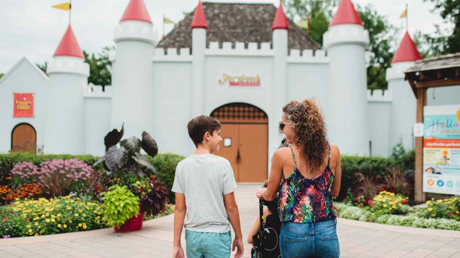 Family walking into Storybook Gardens' castle