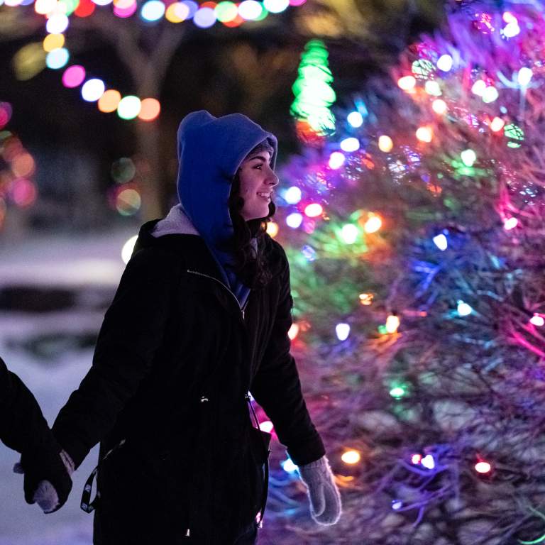 Woman enjoying the holiday lights while on a skating trail